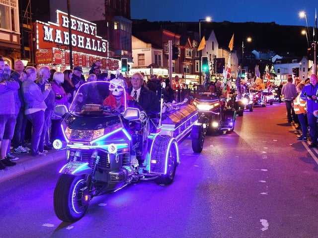 The parade lights up the night.