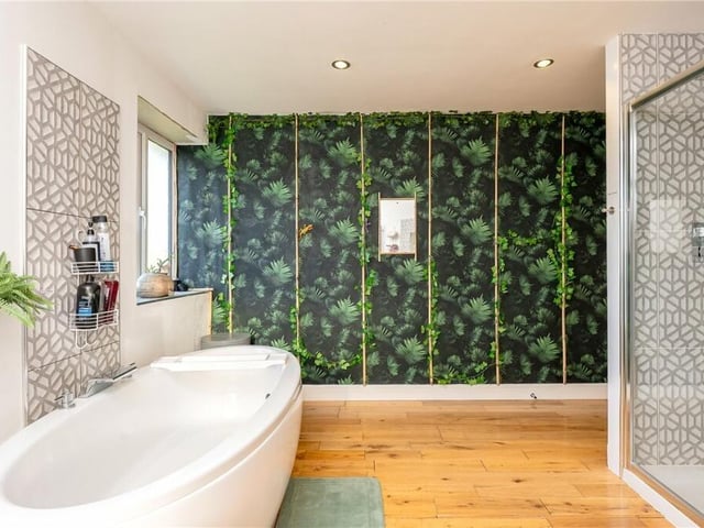A luxury bathroom with both freestanding bath and a walk-in shower.