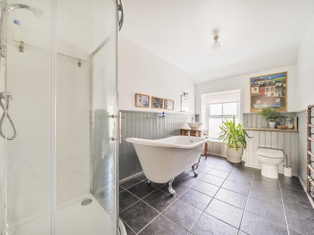 The main house bathroom with free standing bath and walk-in shower.