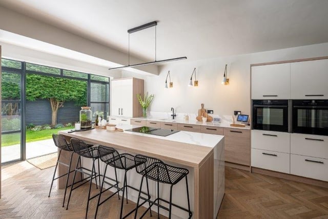 Looking across the breakfast bar, that seats five, to the kitchen units with integrated appliances.