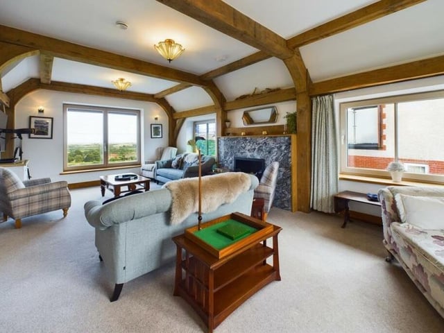 A full-length lounge has a bespoke stained glass window and a striking granite fireplace.