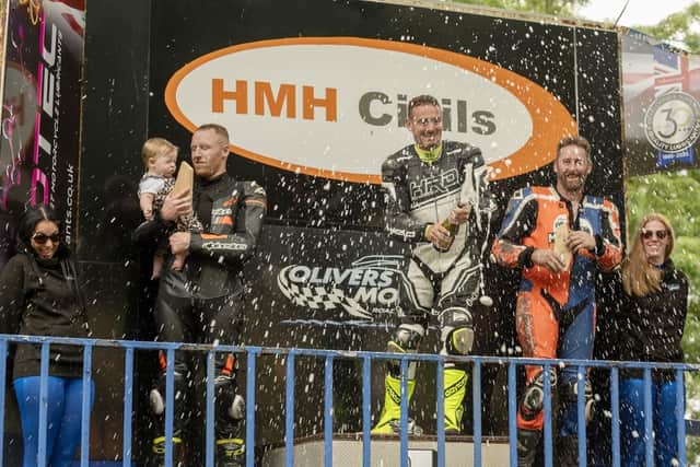 From left, Curtis Milburn (2nd place), Tom Weeden (1st Place) and Scarborough's Paul Marley (3rd place) celebrate their success at the Barry Sheene Festival with champagne. Photo by Ian Ashbridge