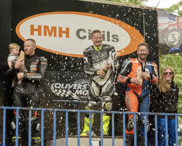 From left, Curtis Milburn (2nd place), Tom Weeden (1st Place) and Scarborough's Paul Marley (3rd place) celebrate their success at the Barry Sheene Festival with champagne. Photo by Ian Ashbridge