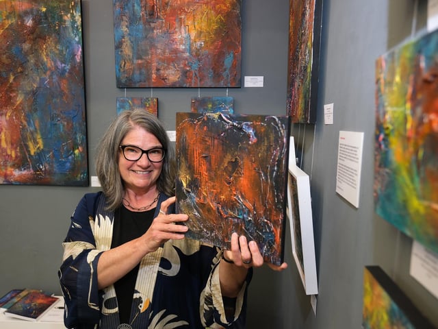 Kimberli Werner at Gallery 33 with her art.