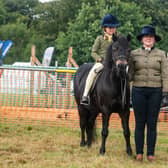 Isabelle Bunyan, of Egton, riding Cayberry Stringfellows, held by her mum Louise Bunyan, at the 2022 Egton Show.