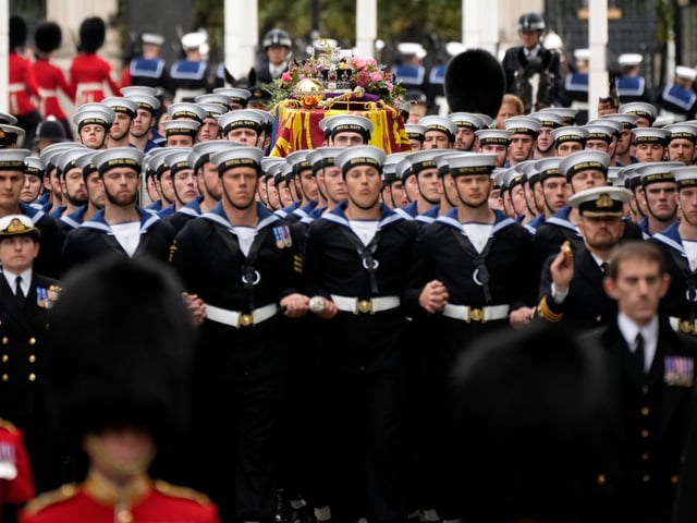 The coffin of Queen Elizabeth II with the Imperial State Crown resting on top surrounded by members of the Royal Navy is carried into Westminster Abbey.  (Photo by Christopher Furlong/Getty Images)
