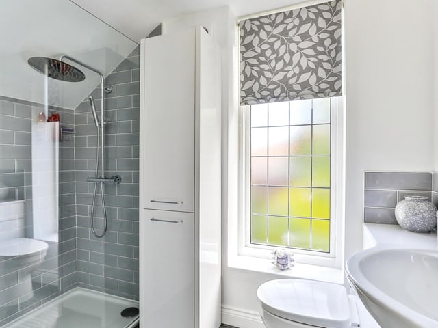 A modern, walk-in shower is a feature of this bathroom.