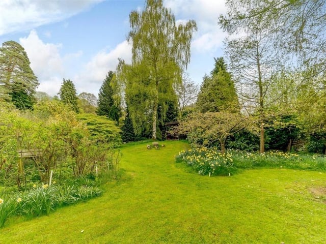 Shaped lawns and filled flower beds contribute to the beautiful setting.