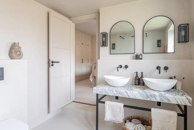 An en suite bathroom with twin washbasins.