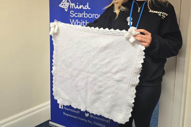 Mind worker Katie Riby with the first blankets and booties made