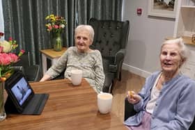 Shirley Wheatley and Pat Wood watching the Barchester virtual events and flower arranging.