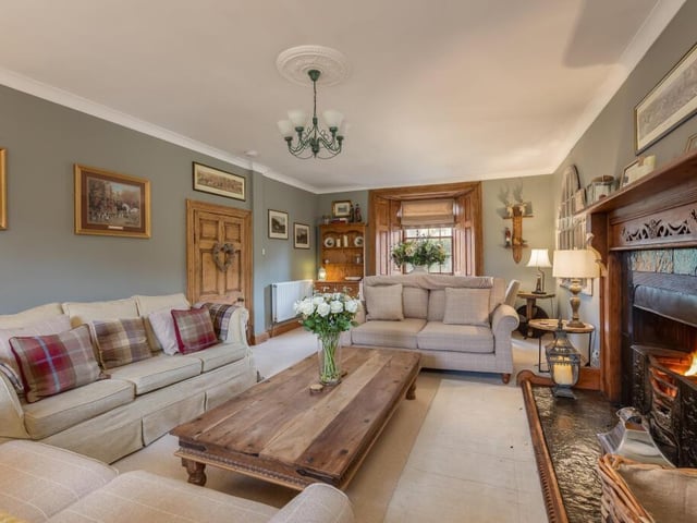 The impressive drawing room with its feature fireplace.