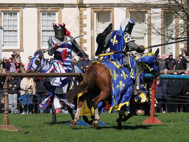Knights joust in front of the historic house.