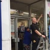Scarborough’s SWC Trade Frames has replaced the smashed window at Saint Catherine’s Hospice’s charity shop free of charge.