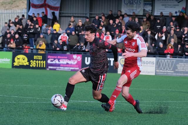 Alex Purver puts a Hereford player under pressure.