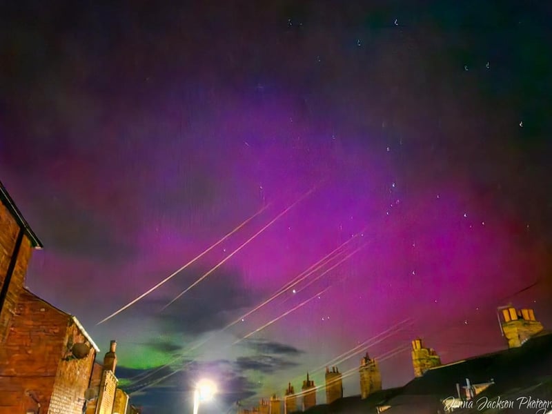 Telephone lines catch the light as the Aurora Borealis glows overhead in Scarborough.