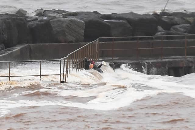 A couple had a lucky escape when they were washed off the harbour wall into the sea at Staithes.
Picture: Gerard Binks.