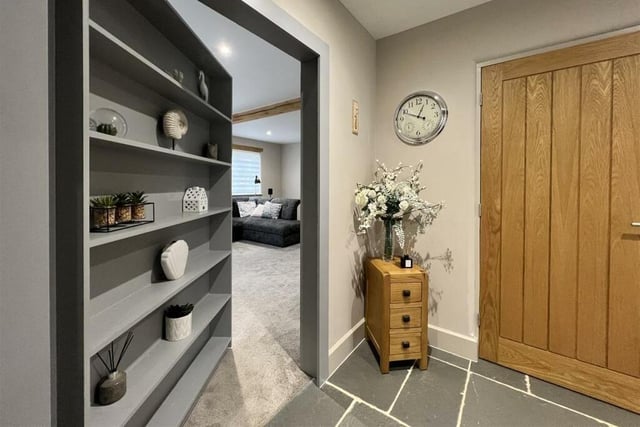 A 'secret' door opens to the plush cinema room from the hallway.