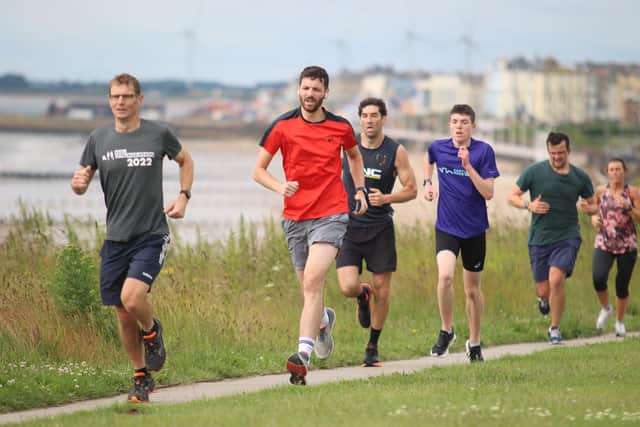 Bridlington Road Runner Micah Gibson, blue shirt, battles his way to a 17th-placed finish at the Sewerby Parkrun.