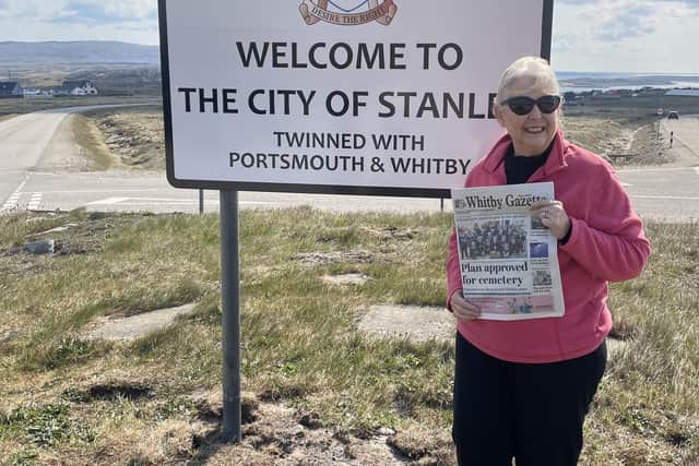 Whitby Town Mayor, Cllr Linda Wild, with her copy of the Whitby Gazette at the City of Stanley, Falkland Islands.