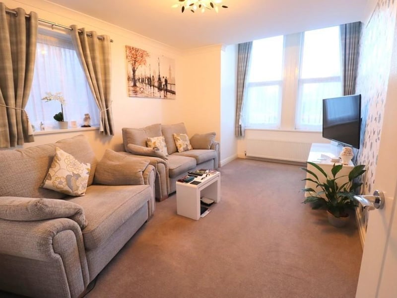 A double aspect sitting room within the spacious apartment.