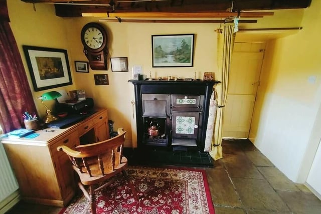 A feature range fireplace within a beamed back room.