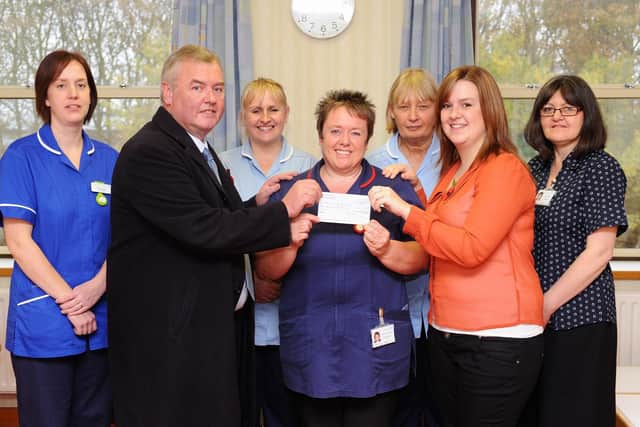 Flamborough Victoria Club members present a cheque at Bridlington Hospital. (PA1145-9)