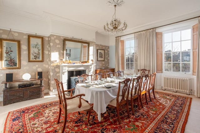 This elegant dining room, with central fireplace, has space for a large dining suite.
