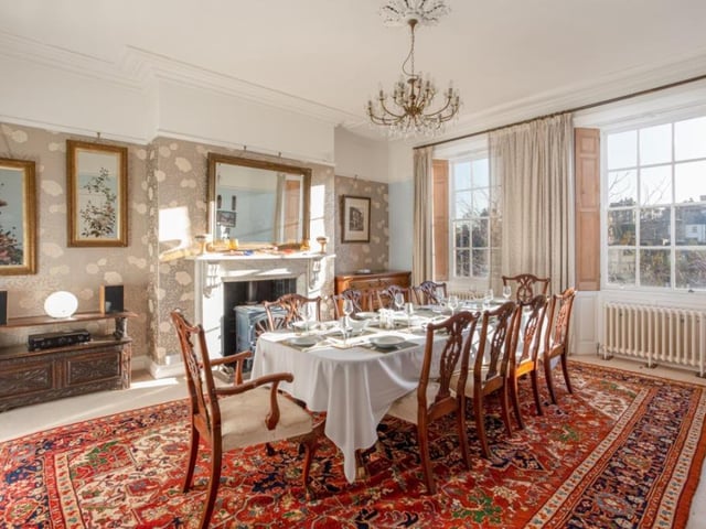 This elegant dining room, with central fireplace, has space for a large dining suite.
