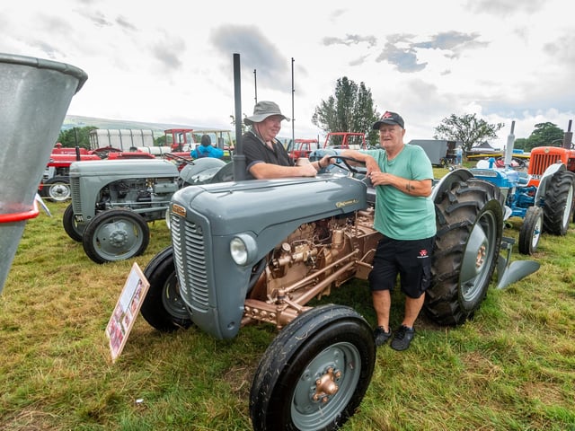 Eugene Barry, from Ireland, chats with exhibitor Ray Green, of Whitby, who is showing his 1957 Ferguson FE35.