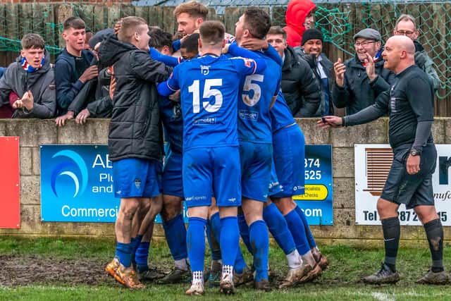 The players and fans cheer the late winner.