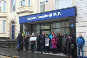 Protestors gather outside Sir Robert Goodwill's constituency office in Scarborough.