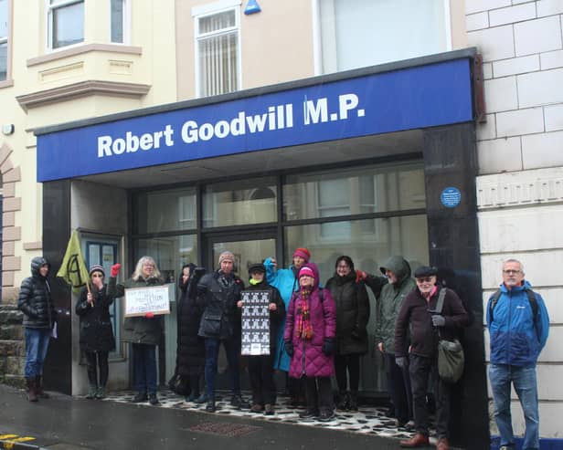 Protestors gather outside Sir Robert Goodwill's constituency office in Scarborough.