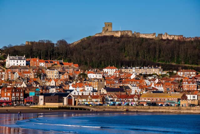 The early evening sun casts a golden glow over the properties and businesses overlooking South Bay, Scarborough, on Yorkshire's east coast.