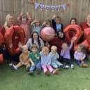 Team members and children at Partou Woodlands House celebrating their success