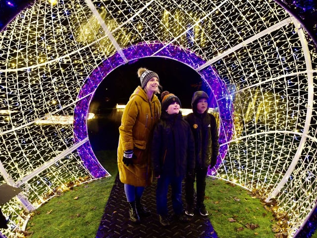 The shimmering giant bauble is the perfect place for a family photo.