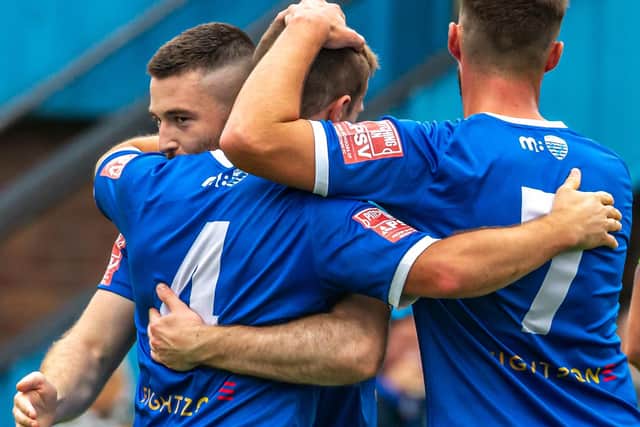 From left, Brad Fewster, Gell and Hawkins celebrate Gell's goal.