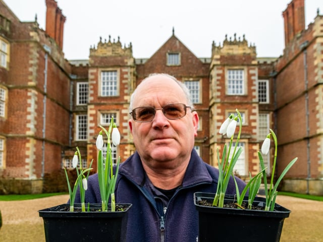 Jeremy Palmer, holding a couple of Snowdrop plants which visitors can purchase.