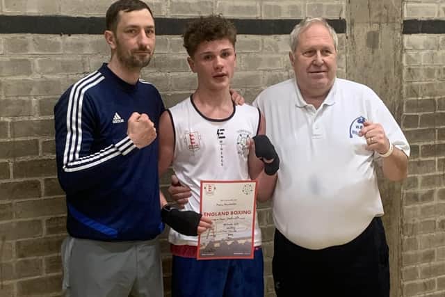 Whitby Boxing Club youngster Mason Stainthorpe, centre, has won a Yorkshire Junior title.