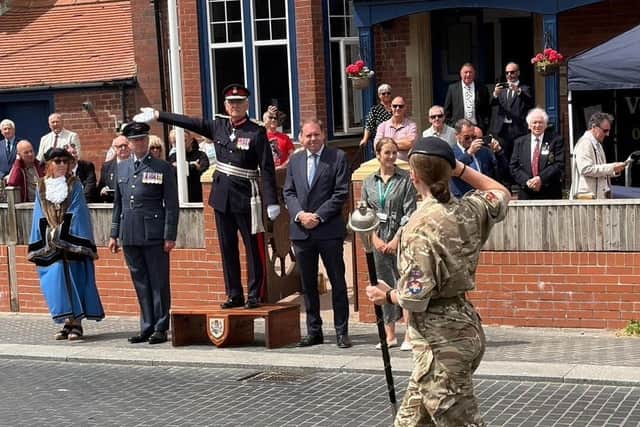 Saluting Dias, including the Lord Lieutenant, as the parade passes by.