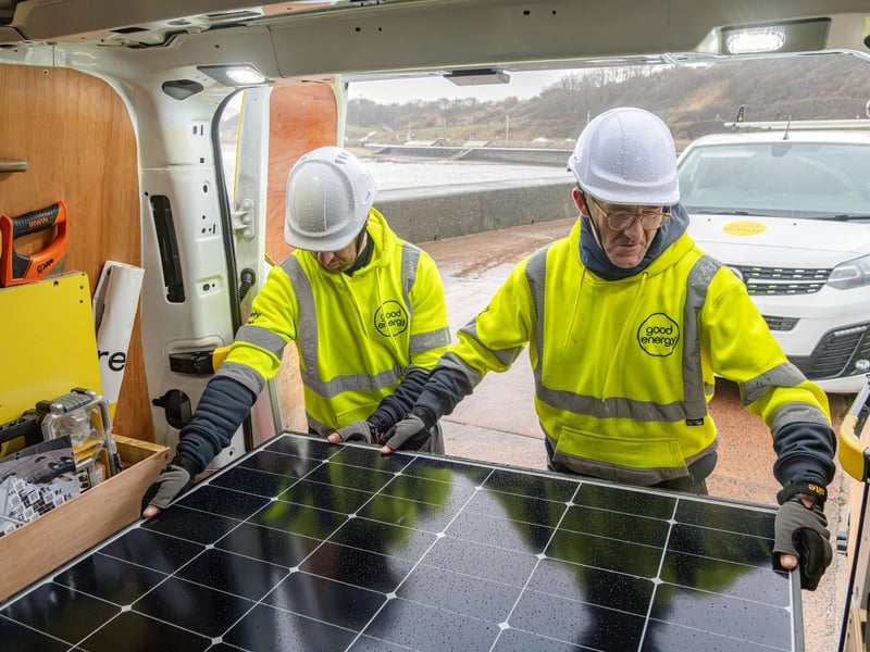 Solar engineers fix a row of solar panels, completing a complex installation on the roofs of SEA LIFE, Scarborough. Photo by Toby Smith / Good Energy.