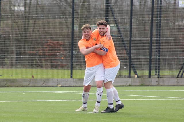 Goal scorers Tommy Wilson and Joe Gallagher celebrate a Wilson goal.