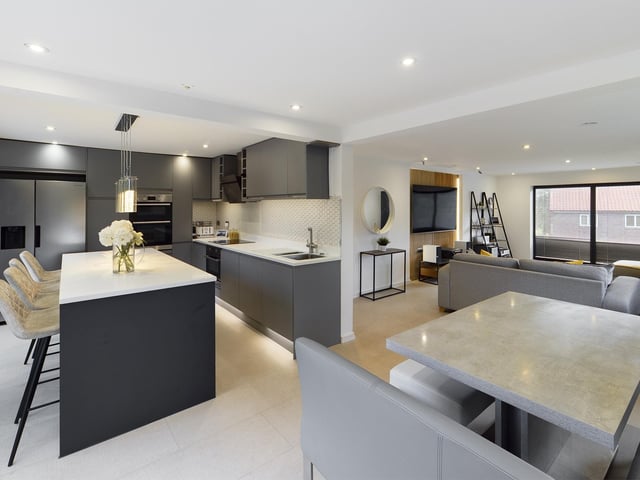 The kitchen flows through to the dining area, and the lounge.