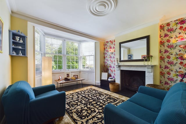 A bay-fronted lounge with feature fireplace.