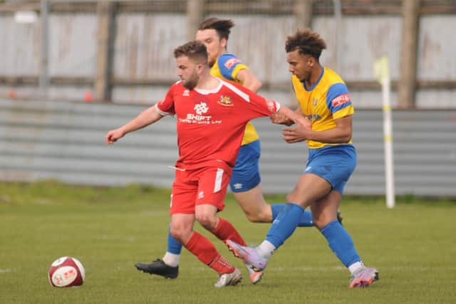 A Stocksbridge Park Steels player gets to grips with Bridlington Town's Andy Norfolk in the 1-0 win for the Seasiders. PHOTOS BY DOM TAYLOR