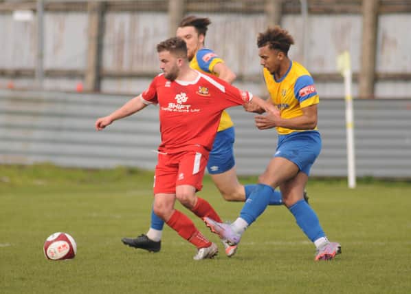 A Stocksbridge Park Steels player gets to grips with Bridlington Town's Andy Norfolk in the 1-0 win for the Seasiders. PHOTOS BY DOM TAYLOR