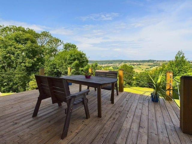 A decked seating area with panoramic views.