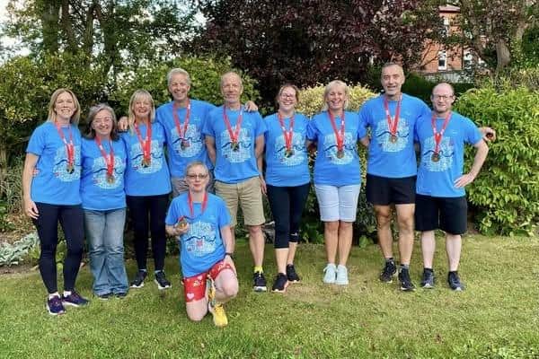 More Scarborough AC runners show off their Great North Run medals.