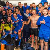 Whitby Town players and staff celebrate their 3-1 home win in the FA Cup against Chelmsford City, earning them a first round trip to Bristol Rovers. PHOTOS BY BRIAN MURFIELD