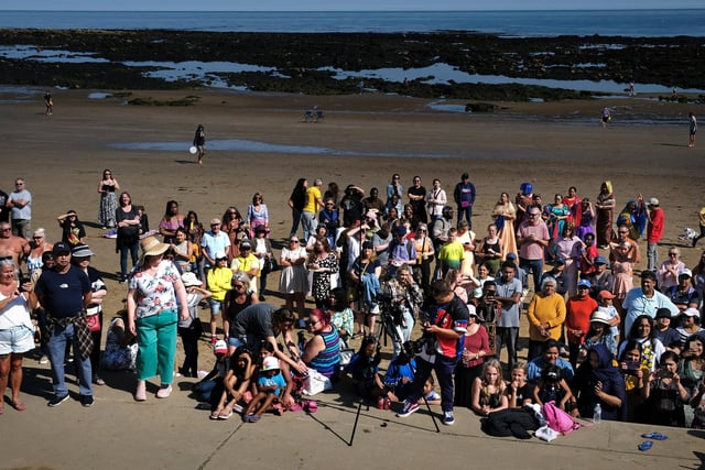 A large crowd gathered on the beach to enjoy the day